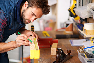Man, focus wood and tape measure for construction, home development and building renovation. Carpenter, maintenance employee and male repairman worker on a contractor job of builder working in house
