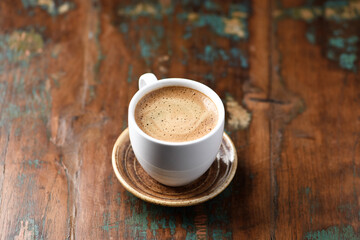 Cup of coffee on wooden background. Close up.	