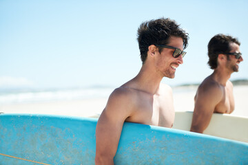 Beach, summer and man surfer friends bonding outdoor on vacation or holiday travel overseas. Surf, sea or fun with a happy young male and friend in sunglasses surfing together on an ocean coast