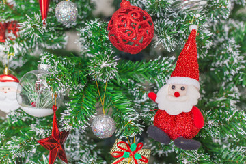 Fir tree or green branch decorated with red, golden and silver colors things as a Christmas or New year background.