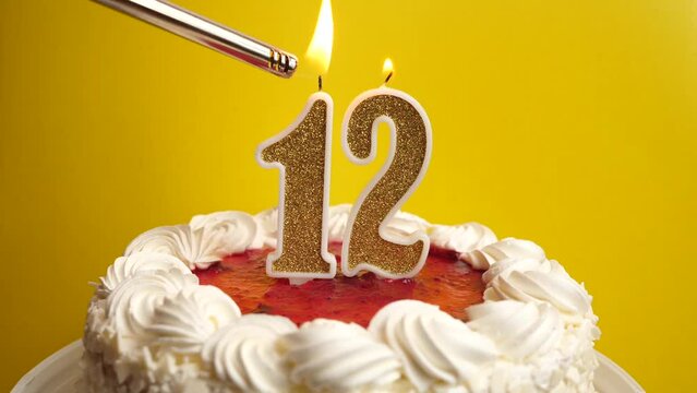 A candle in the form of the number 12, inserted into the holiday cake, is lit. Celebrating a birthday or a landmark event. The climax of the celebration.