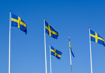 Swedish flag on flag pole and clear blue sky