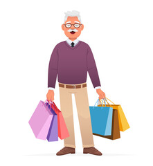 A happy elderly man in glasses stands with multi-colored paper bags from shopping. An old gray-haired grandfather with packages goes shopping.