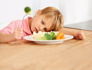 Sad, hungry and a child with vegetables for dinner, unhappy and problem with food. Frustrated, diet...