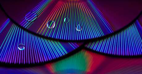 abstract rainbow light rays reflection on cd surface with water drops