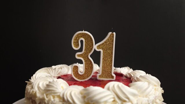 A candle in the form of the number 31, inserted into the holiday cake, is blown out. Celebrating a birthday or a landmark event. The climax of the celebration.