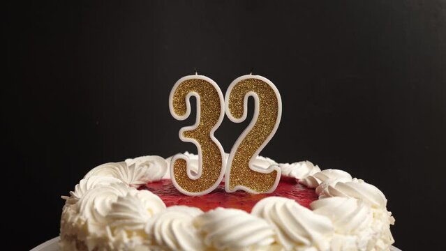 A candle in the form of the number 32, inserted into the holiday cake, is blown out. Celebrating a birthday or a landmark event. The climax of the celebration.