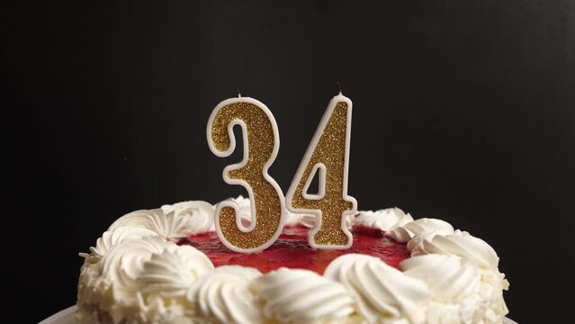 A candle in the form of the number 34, inserted into the holiday cake, is blown out. Celebrating a birthday or a landmark event. The climax of the celebration.