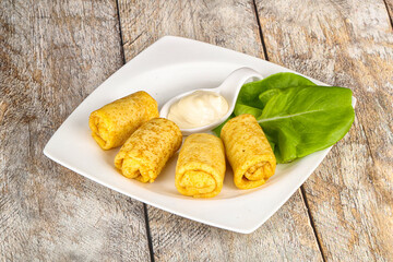 Stuffed pancakes with cream sauce