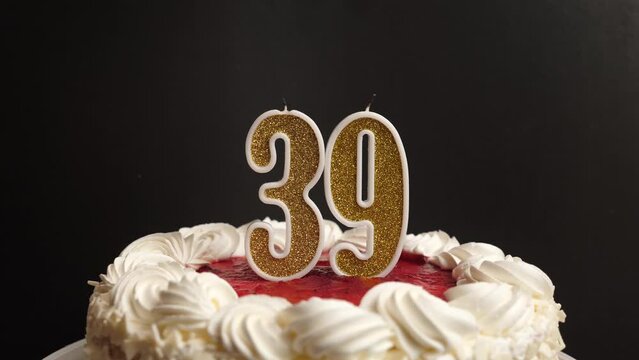 A candle in the form of the number 39, inserted into the holiday cake, is blown out. Celebrating a birthday or a landmark event. The climax of the celebration.