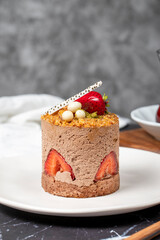 Strawberry, Croquant and Pistachio Cake. Delicious cream cake on dark background. Close up