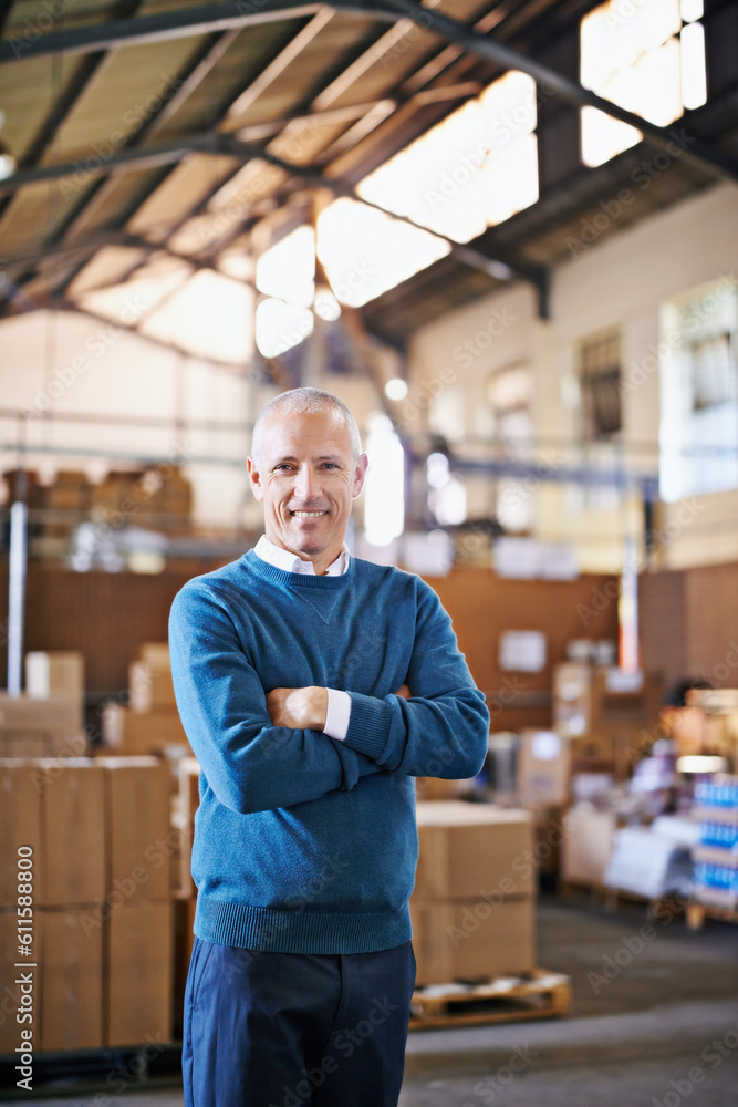 Wall mural Arms crossed, smile and portrait of man in warehouse for cargo, storage and shipping. Distribution, ecommerce and logistics with employee in factory plant for supply chain, package and wholesale