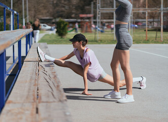 Fit, seductive, flexible sportsgirl exercising in the park