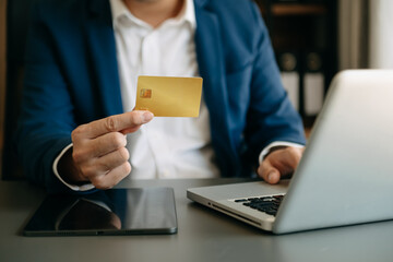 Man using smart phone for mobile payments online shopping,omni channel,sitting on table,virtual icons graphics interface screen