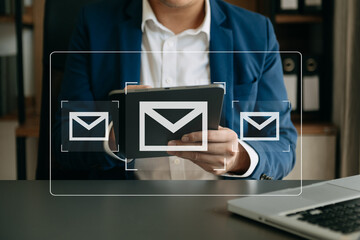Man hands using Laptop, tablet typing on keyboard and surfing the internet with email icon, email marketing concept, send e-mail or newsletter, online working internet network technology..