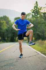 Obraz premium Full length of handsome sportsman warming up before running in the morning. Fitness, sport and healthy lifestyle concept