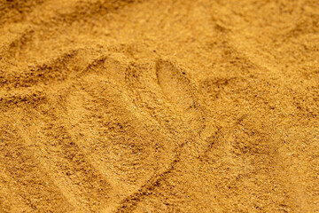 Pile of cinnamon powder as background, spice or seasoning as background. Close-up cinnamon powder