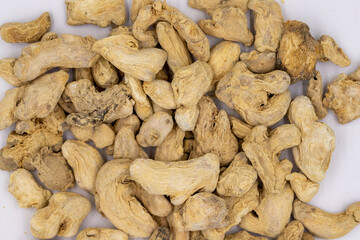 Pile of Dried Ginger root as background, spice or seasoning as background. Close-up ginger root or Dry Adrak