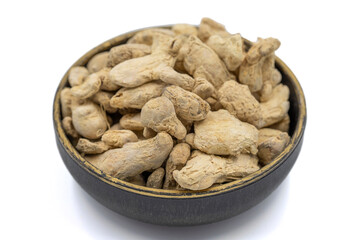 Dried Organic Ginger root isolated on white background. Ginger root or Dry Adrak in bowl