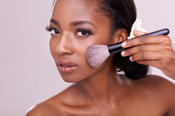 Portrait, makeup and black woman with brush in studio, cosmetic application tool and glamour....