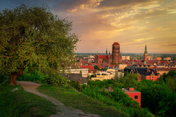 Beautiful cityscape of Gdansk with St. Mary Basilica and City Hall at sunset, Poland.
