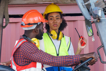 group of two african american engineer talking with colleague on forklift  loading Containers box...