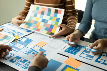 The UxUi development team met to discuss the project at the brainstorming concept conference table,...