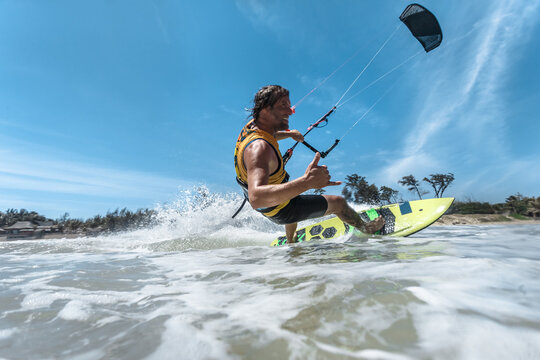 A kite surfer rides the waves