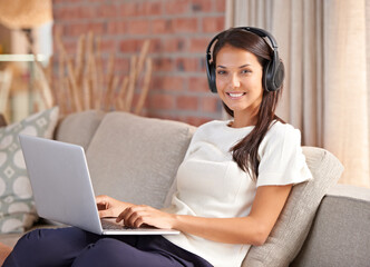 Headphones, laptop and portrait of a woman student on home sofa listening to music or streaming online. Happy female person smile, relax and learn new language with internet connection and tech