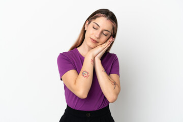 Fototapeta premium Young caucasian woman isolated on white background making sleep gesture in dorable expression