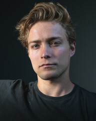 Fototapeta premium A man in a dark room looking directly at you