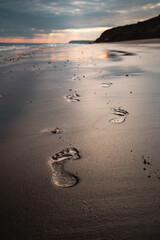 A coastal walk along the shoreline at sunset
