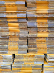 Background of many brown foldable cardboard boxes stack for packaging in vertical frame