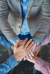 Collaboration, top view and hands together for cooperation, team building or solidarity. Teamwork, hand huddle and group of people with motivation, trust or support for community goals in partnership