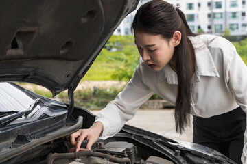Plakat Office woman driver checking with opened hood car problem on the road, auto breakdown and repair service