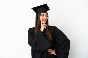 Young university graduate isolated on white background thinking an idea while looking up