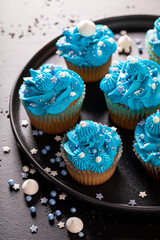 Beautiful and unique cupcakes with blue whipped cream.