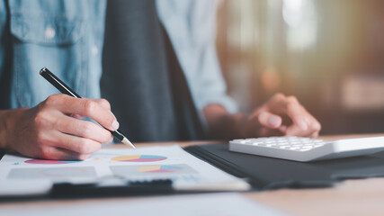 statistical analyst using calculator to calculate and read reports, graphs and charts, business statistics ,Analysis and improvement of corporate strategy ,Statistics and Data Concepts