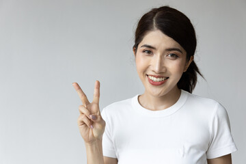 asian woman pointing up two fingers, v for victory