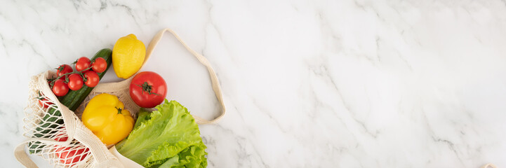 string bag banner,Reusable mesh bag for eco-conscious shoppers with vegetables and fruits,responsible shopping,copy space