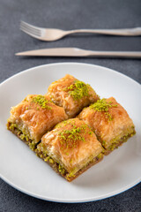 Pistachio Turkish baklava on a white plate.Traditional delicious Turkish baklava
