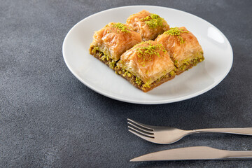 Pistachio Turkish baklava on a white plate.Traditional delicious Turkish baklava
