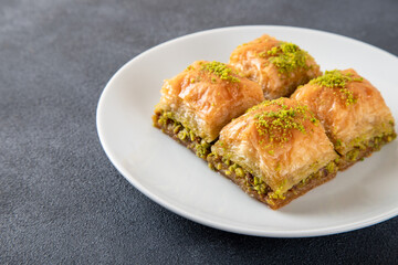 Pistachio Turkish baklava on a white plate.Traditional delicious Turkish baklava
