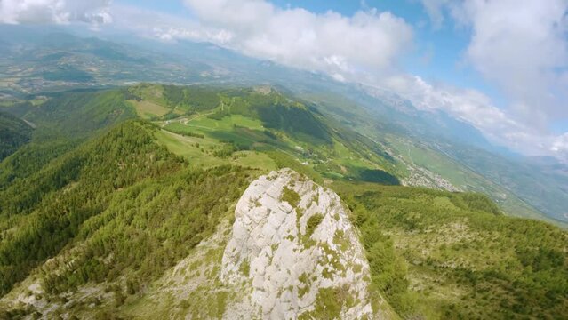 Dynamic fpv drone flight on top of a high alpine mountain during spring