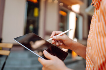 Hands of man using tablet close-up. Business, technology, freelance, graphic concept