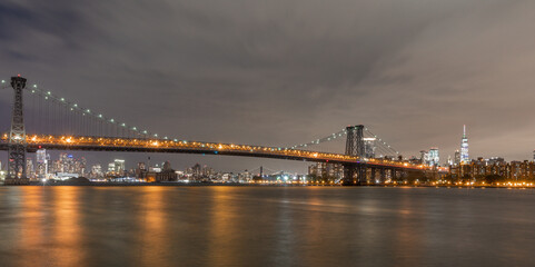 Fototapeta na wymiar View of the Brooklyn, Manhattan and Williamsburg Bridge at night. Long Exposure Photo Shoot.