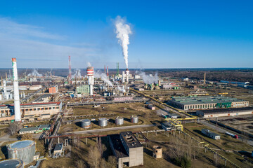 Obraz premium Chemistry Factory in Lithuania, Achema in Jonava City. Clear Blue Sky and Smoke in background. Drone