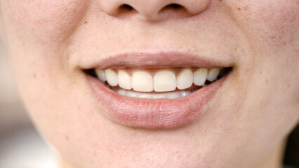 Close shot of female mouth smiling to camera