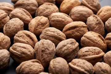 Whole walnuts nuts with shells close-up background studio shot