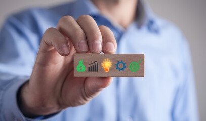 Business symbols on wooden block. Business process. Goal. Achievement